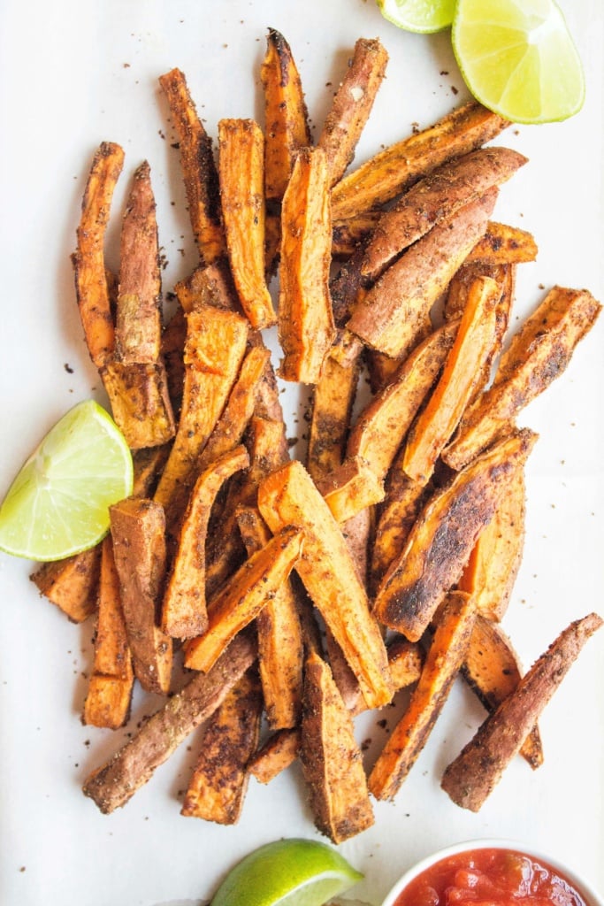 seasoned sweet potato fries with lime wedges