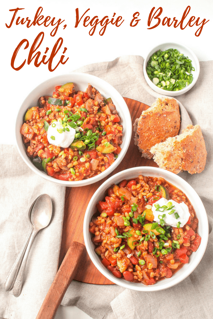 turkey barley soup with veggies in bowls with a side of bread