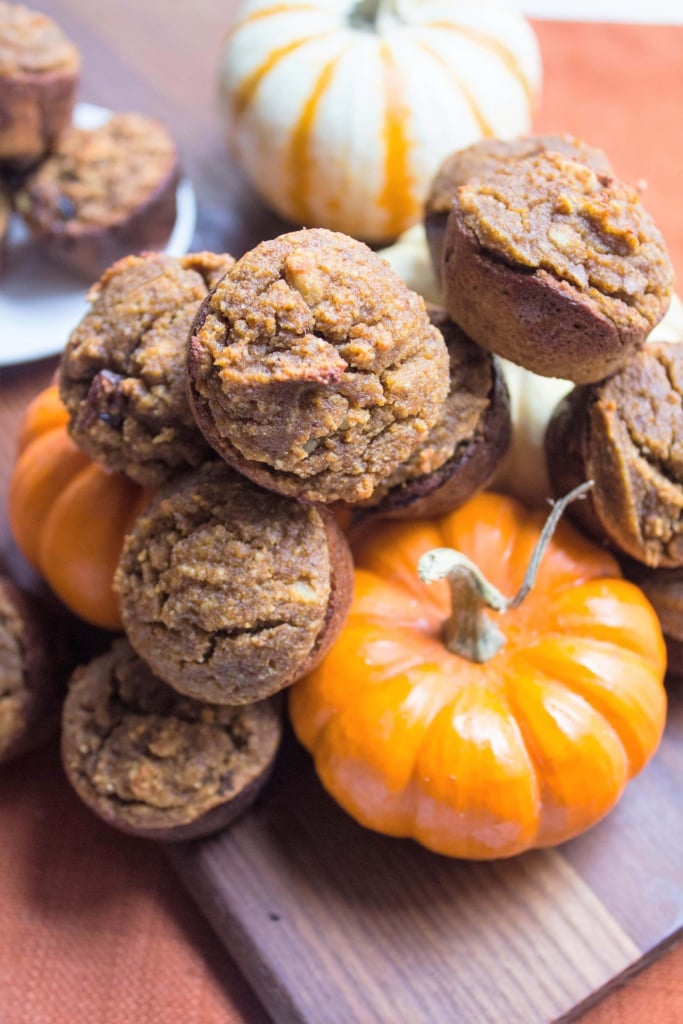 close up of mini gluten free pumpkin muffins on a wooden platter