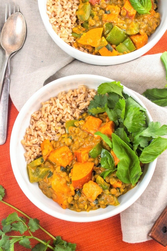 Sweet Potato Lentil Coconut Curry in two white bowls with a linen napkin