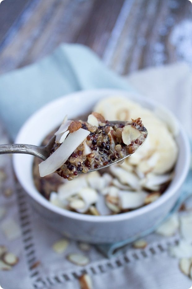 coconut breakfast quinoa on a spoon with a bowl in the background