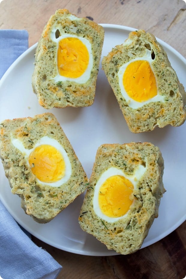 gluten free egg and cheddar muffins cut in half on a plate