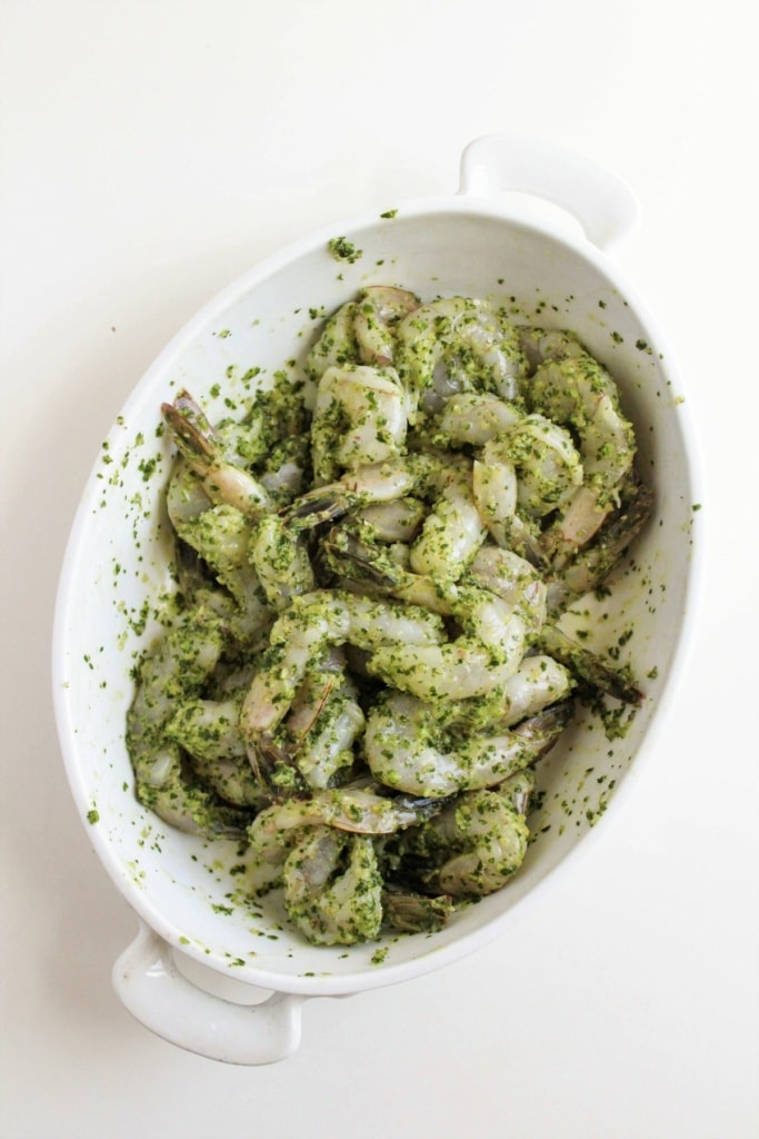 shrimp in a white dish tossed in chimichurri sauce