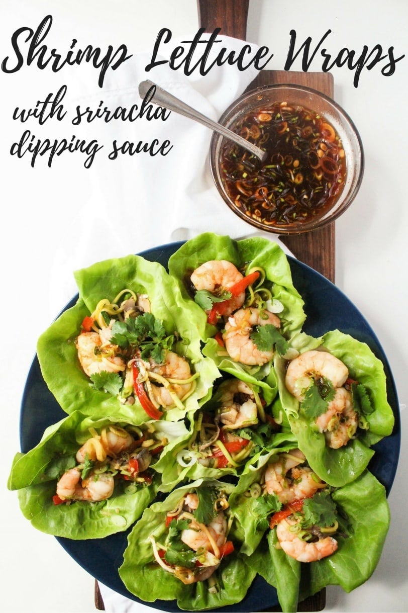 Shrimp lettuce wraps on a plate with sriracha sauce in a small bowl