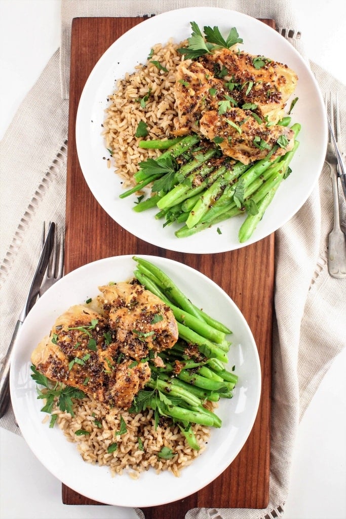 maple mustard chicken thighs on white plates with rice and greens