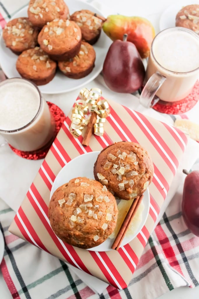 whole wheat muffins with pear and ginger on top of a wrapped holiday present