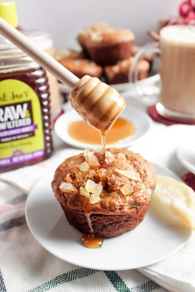 honey being drizzled on a ginger pear muffin