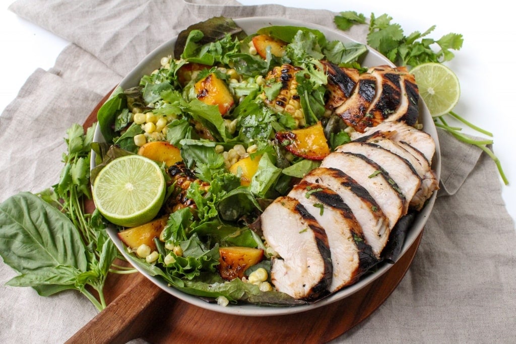 dairy free chicken salad with corn and peaches in a large bowl