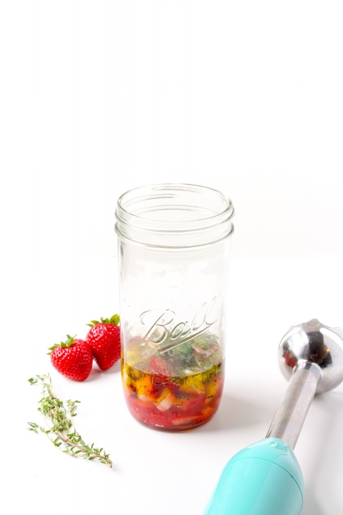 diced strawberries, apple cider vinegar, olive oil, herbs, and garlic in a mason jar