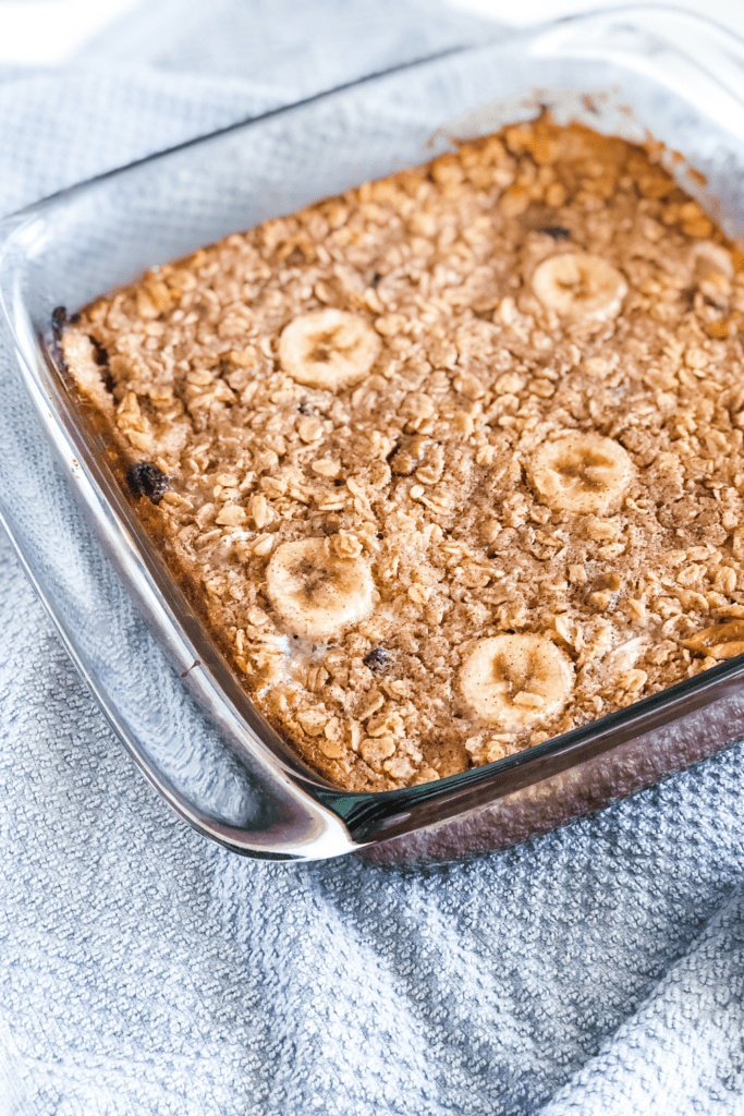 baked oatmeal in a glass baking dish on a grey kitchen towel