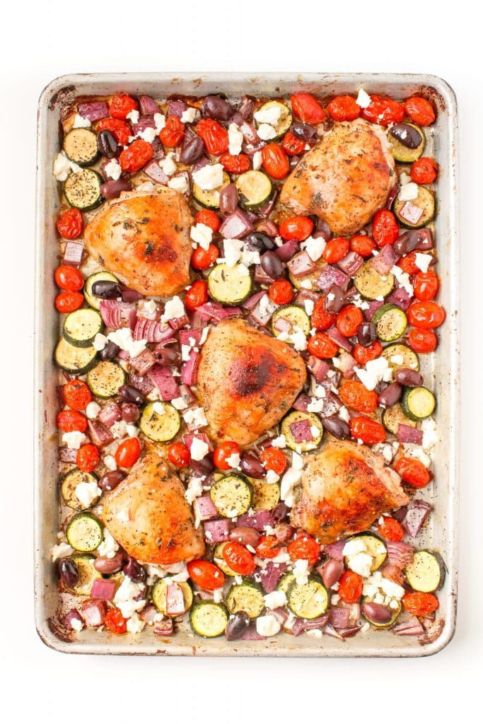 roasted mediterranean chicken thighs on a sheet pan