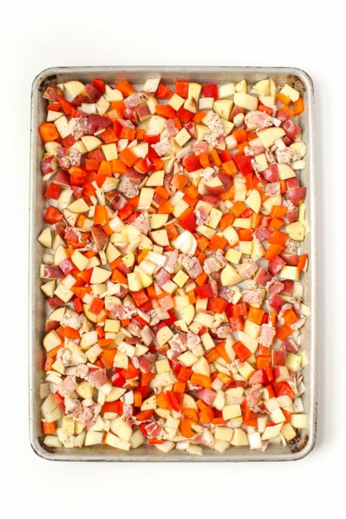 diced vegetables and bacon on a metal sheet pan