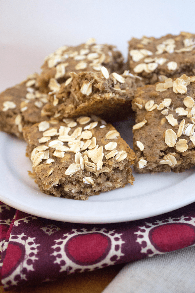 vegan banana breakfast bars with almond butter on a plate