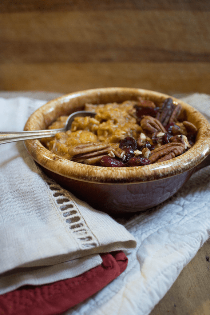 healthy pumpkin pie oatmeal with pecans and dried cranberries