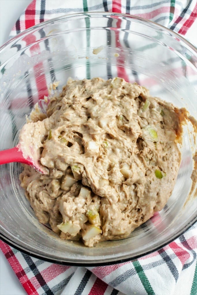 muffin batter in a large glass bowl with a spatula