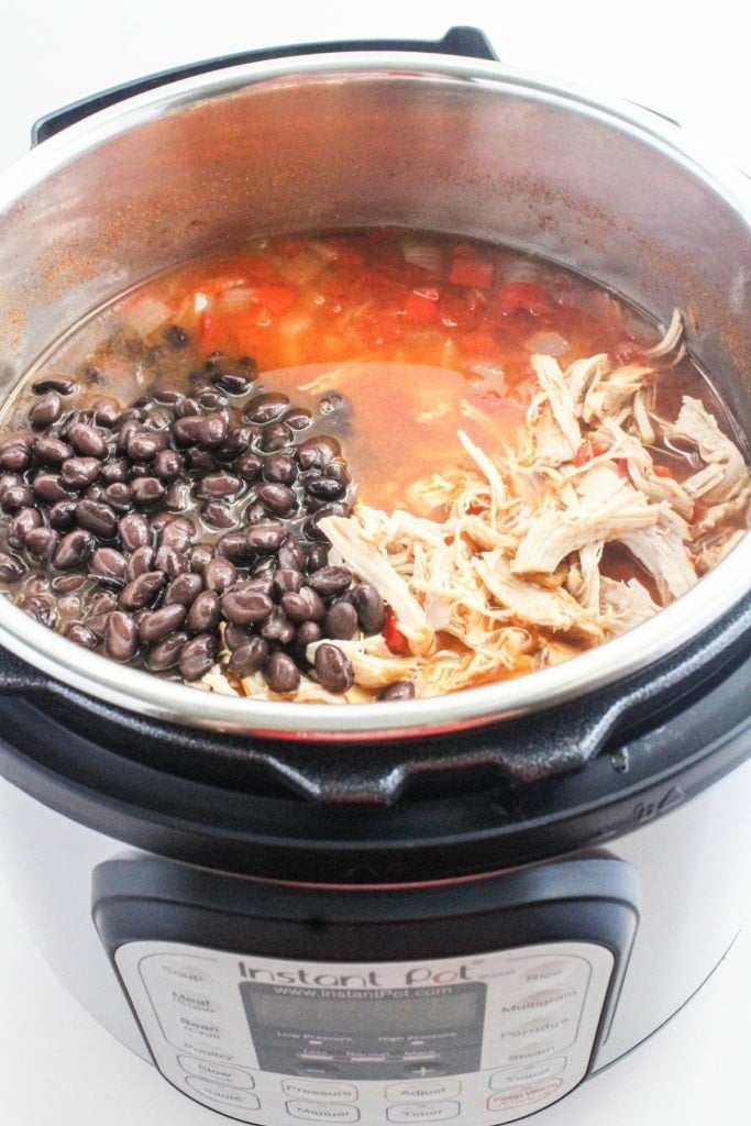 black beans and shredded chicken in an Instant Pot with broth