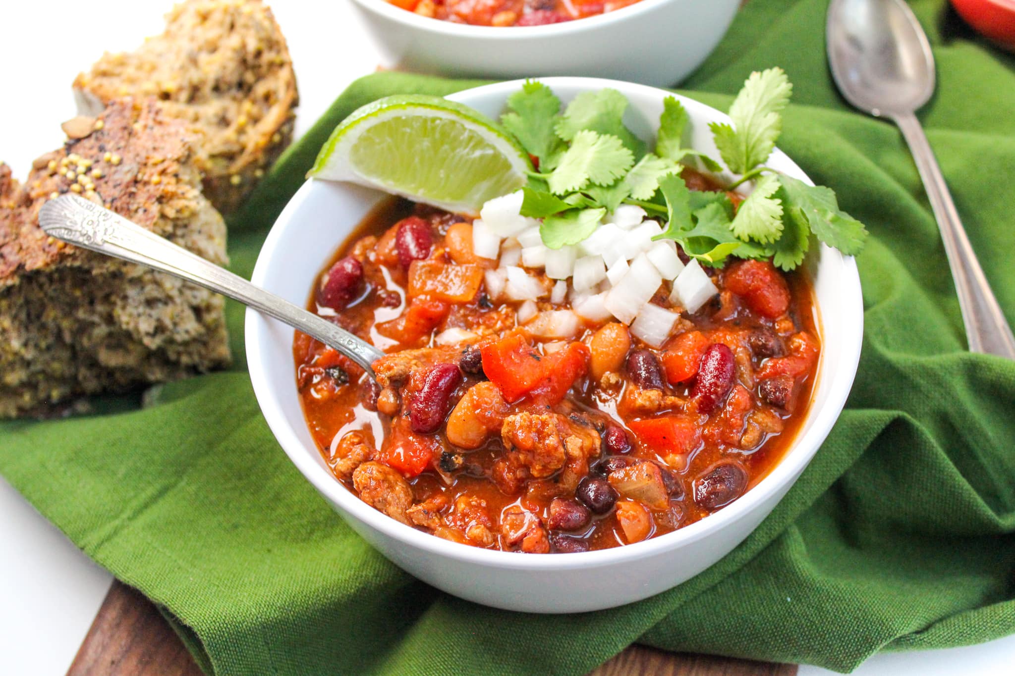 healthy slow cooker turkey chili with lime, onions, and cilantro