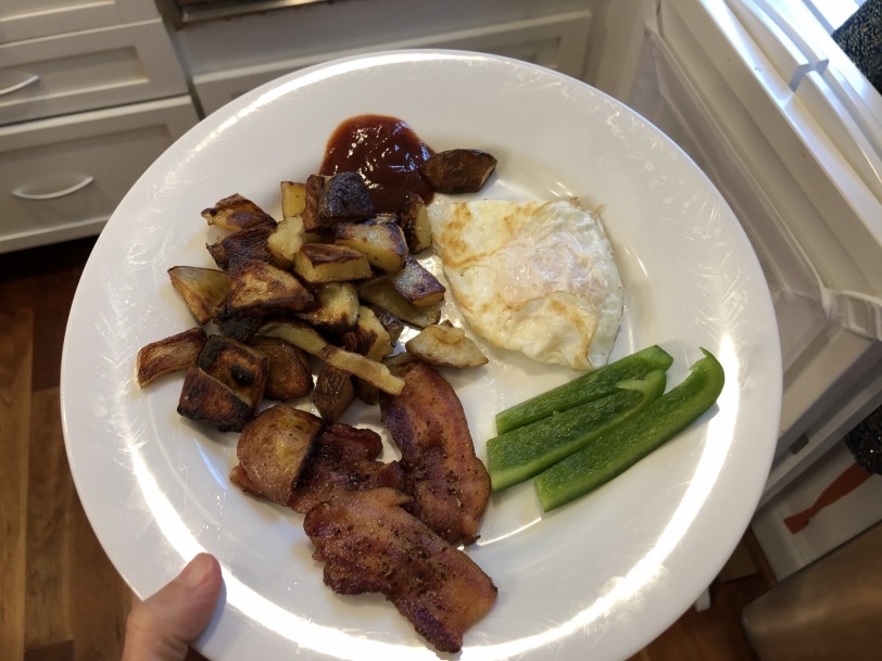 brunch with leftover roasted potatoes, bacon, fried egg, and green pepper