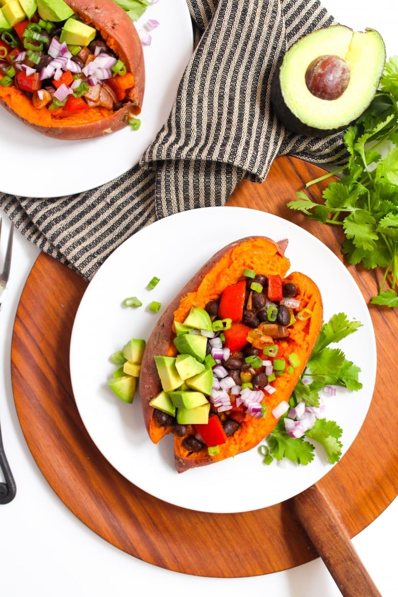 black bean avocado red pepper and onion in a sweet potato on a plate