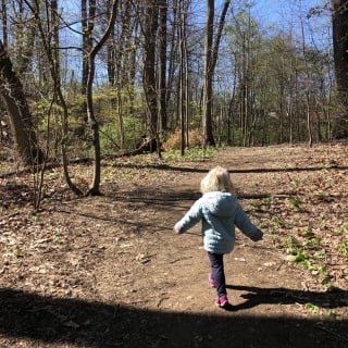 toddler hiking in the woods