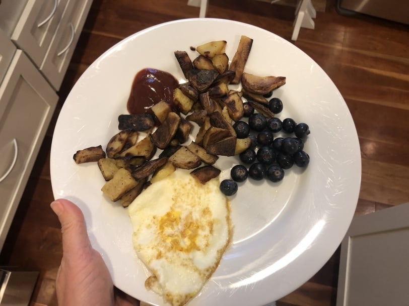 fried egg with leftover roasted potatoes and blueberries
