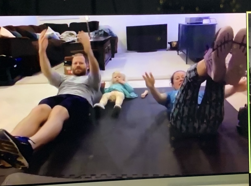 toddler exercising with parents