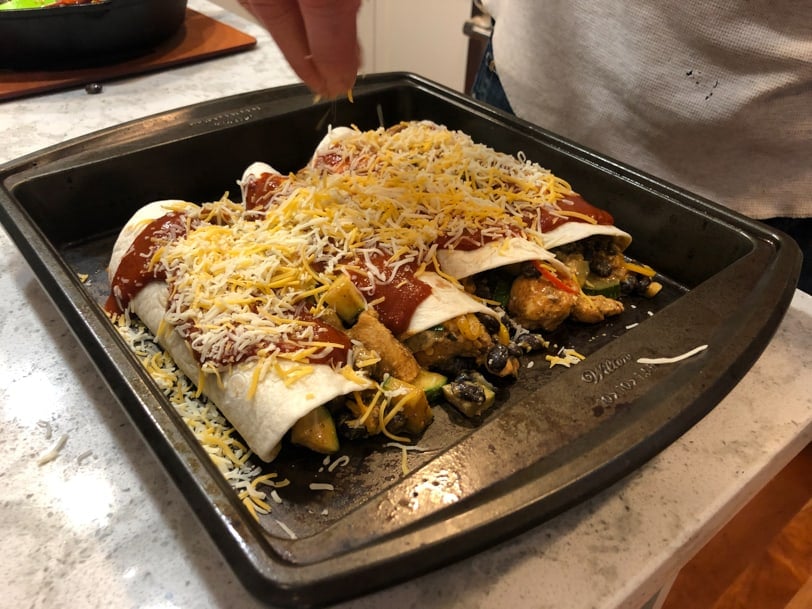 chicken enchiladas with black beans, cheese, zucchini, and peppers
