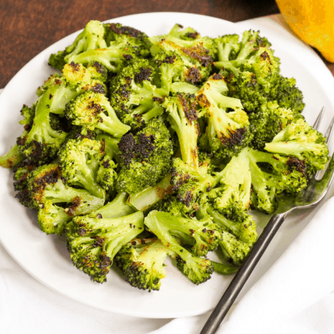 roasted broccoli on a plate with lemons
