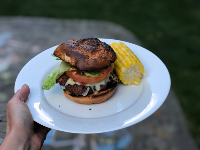homemade cheeseburger with corn on the cob