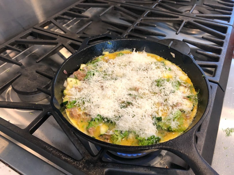 frittata with broccoli and zucchini topped with parmesan