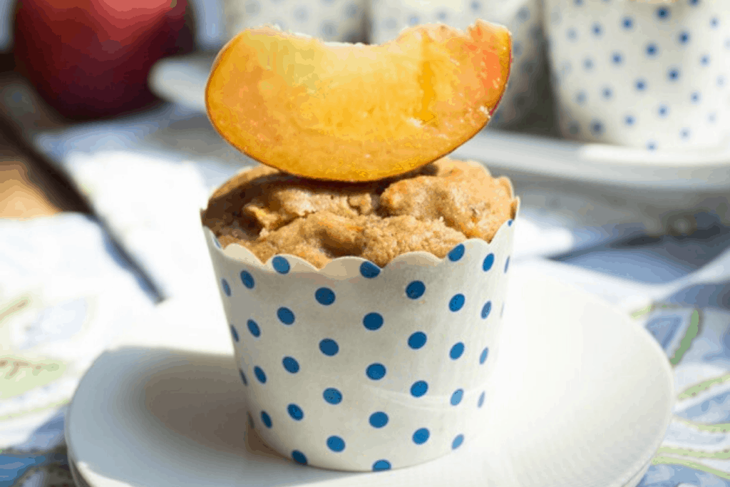 dairy free peach muffins with a peach slice on top