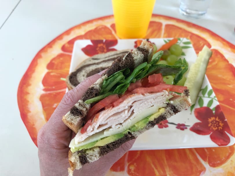 sandwich with turkey, avocado, cheese, tomato, lettuce