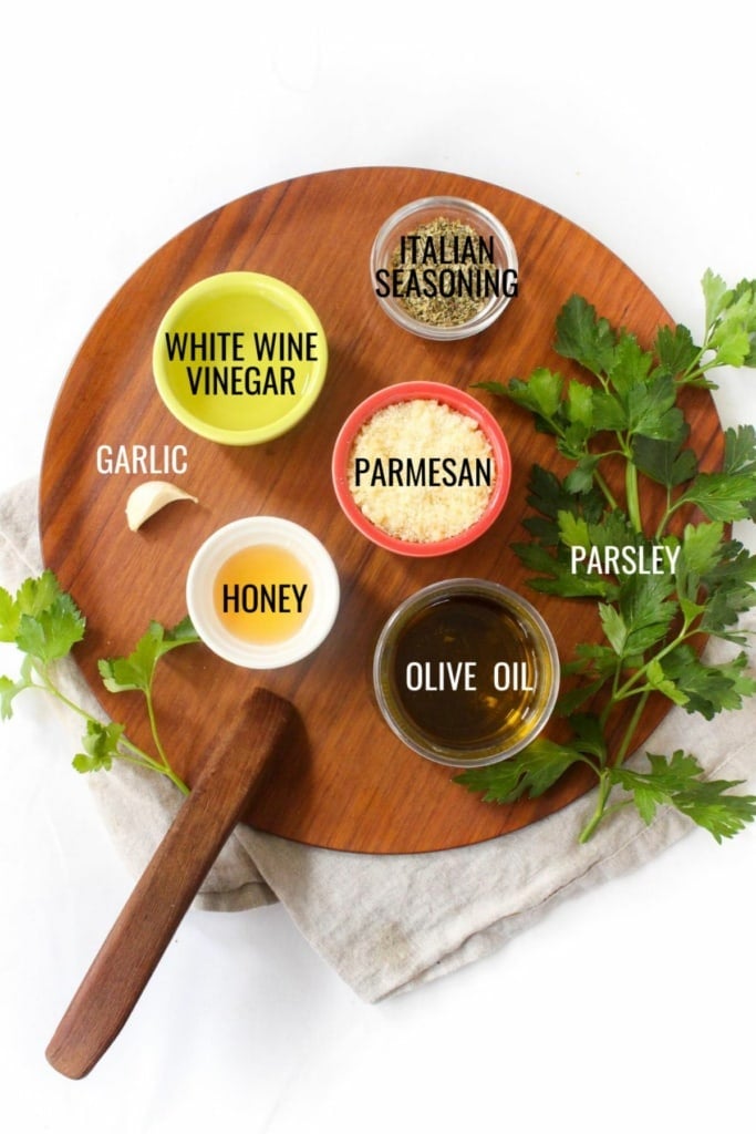 creamy Italian dressing ingredients on a wooden platter