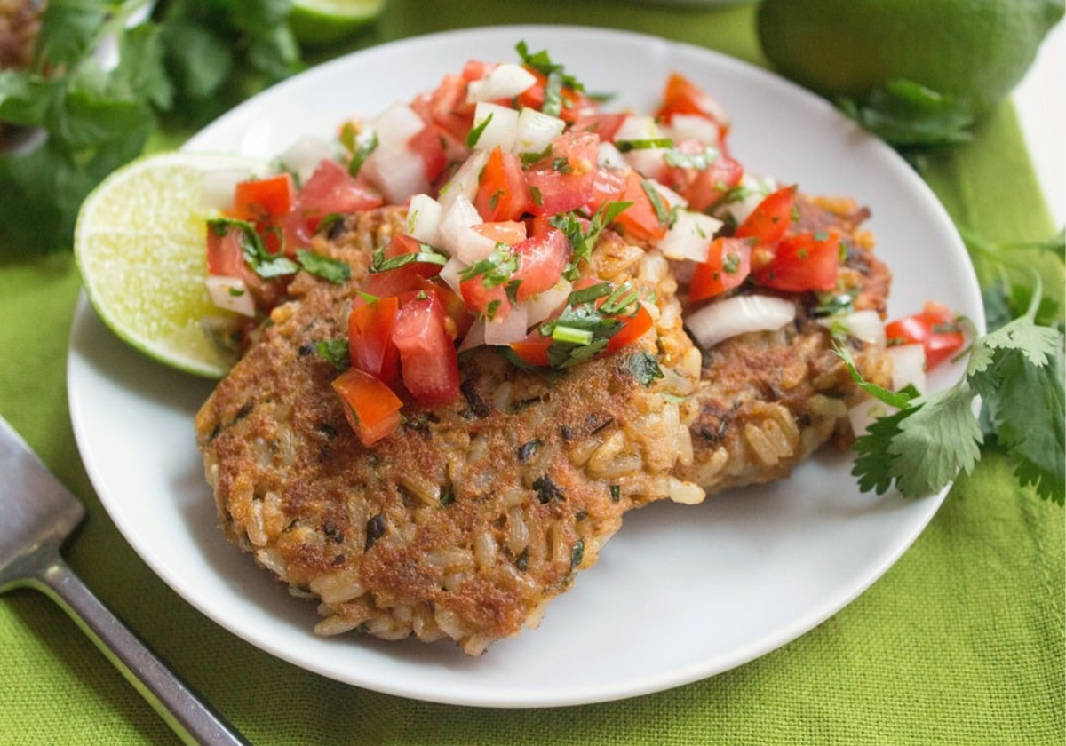 canned salmon patties on a white plate with salsa on top