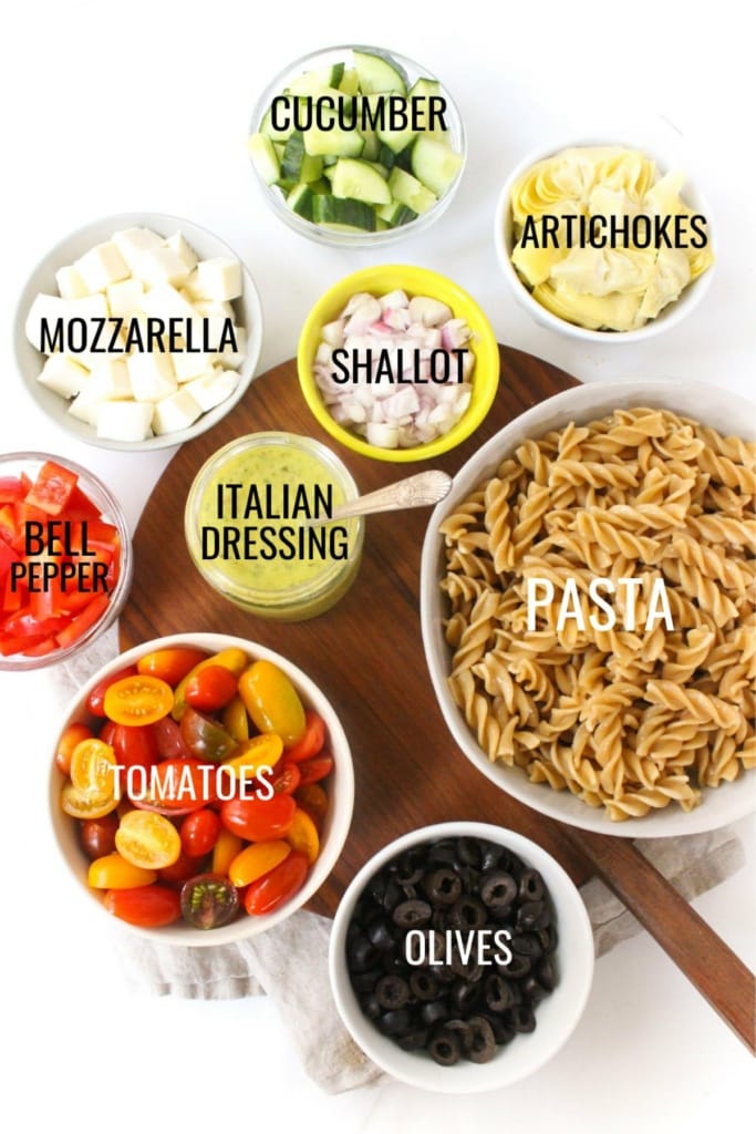 pasta, vegetables, mozzarella cheese, and olives in small bowls