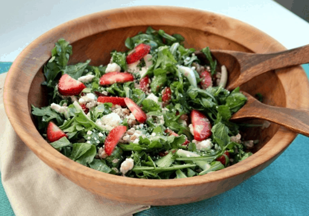 strawberry fennel salad with barley in a large wooden salad bowl