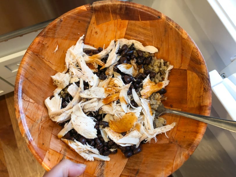 rotisserie chicken with black beans, rice, and hot sauce