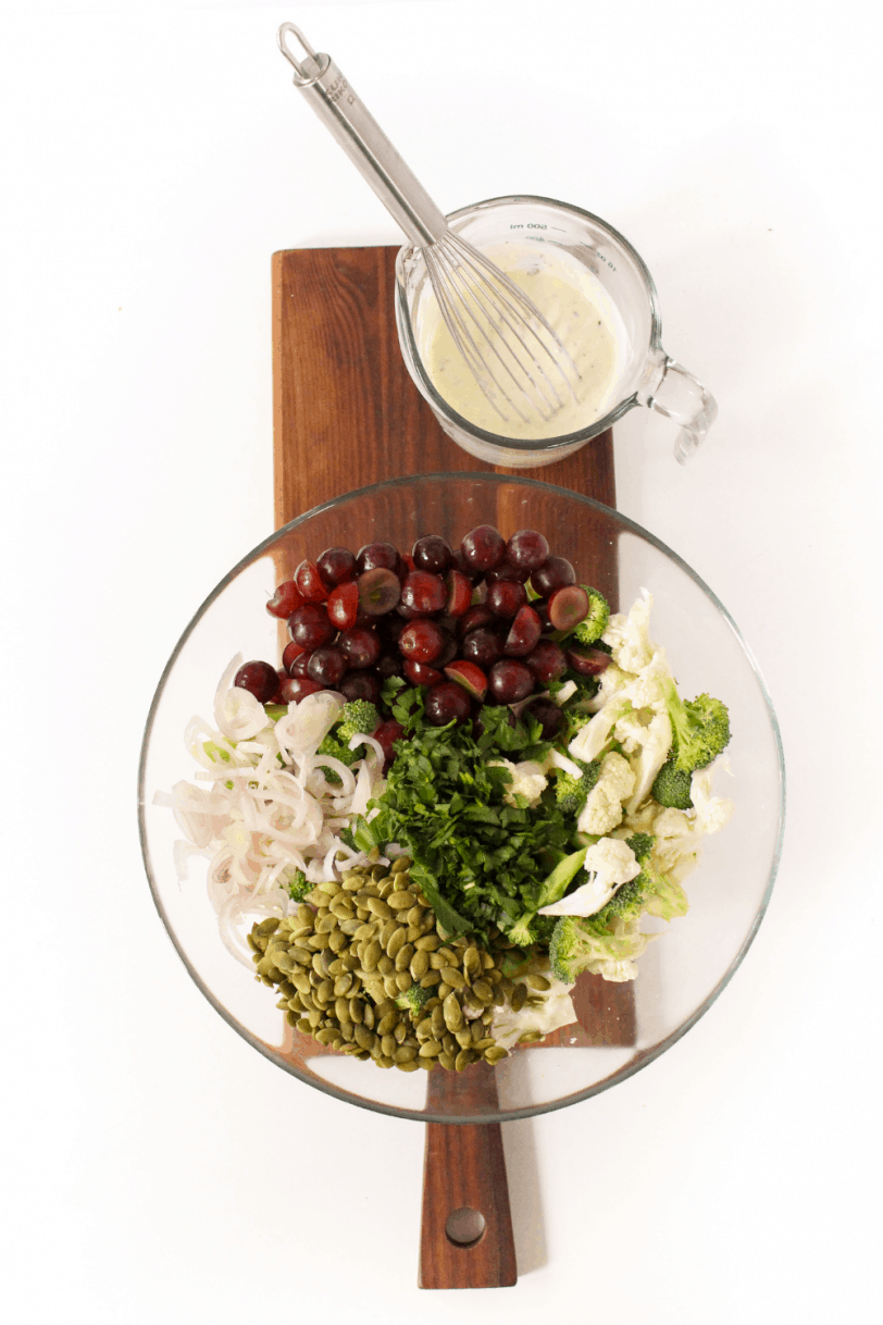 salad ingredients chopped in a bowl with dressing on the side