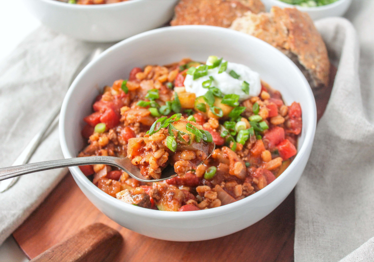 turkey barley soup in a bowl with a spoon