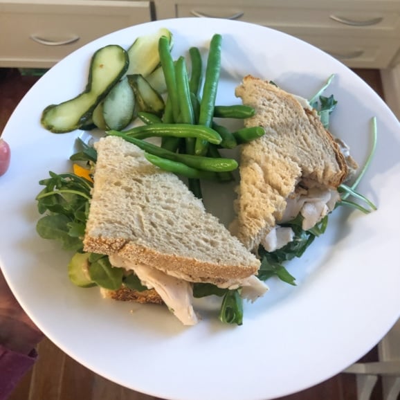 turkey sandwich with cheese, pickles, string beans
