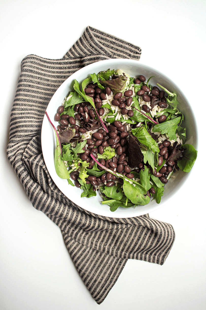 mexican salad bowl base: large bowl with greens and black beans