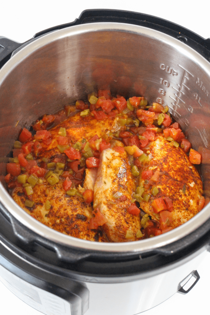 chicken breasts with tomatoes and chilies in the pressure cooker