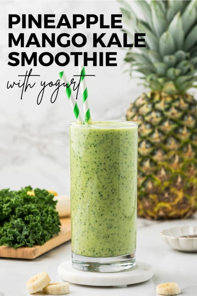 pineapple mango kale smoothie with Greek yogurt in two tall glasses with green striped straws