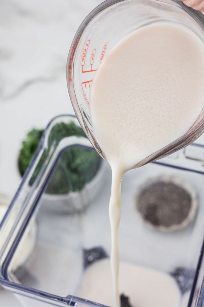 milk being poured into a blender