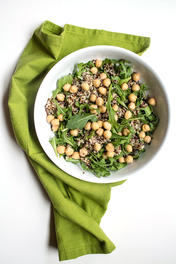 chickpeas and quinoa in a salad bowl with greens