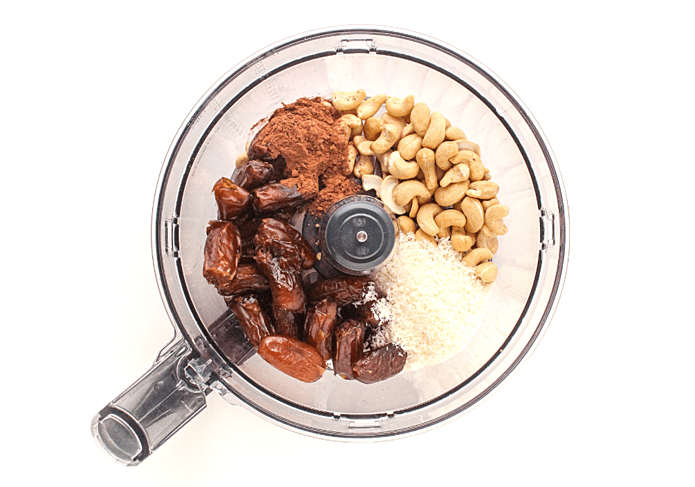 chocolate cashew energy bites ingredients in a food processor