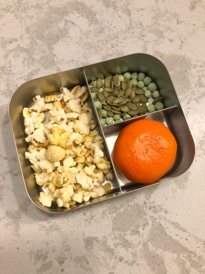 popcorn, pumpkin seeds and peas, clementine