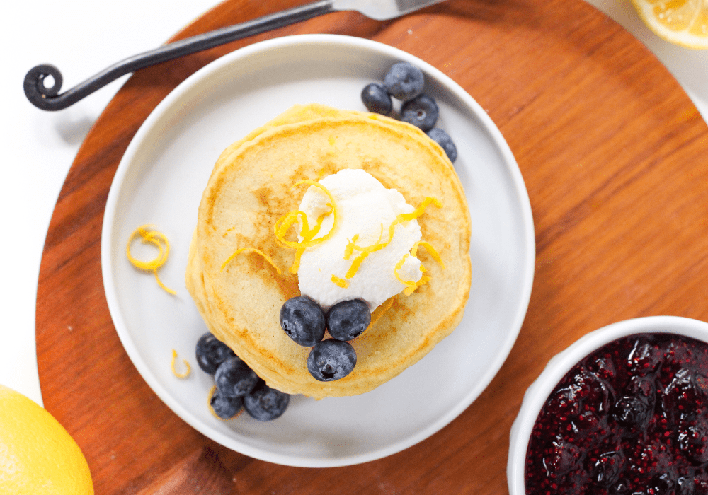 stack of pancakes with blueberries and lemon zest