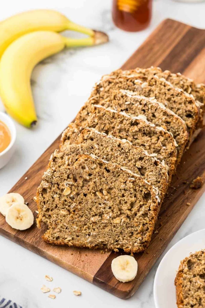slices of whole wheat banana bread on a wooden cutting board