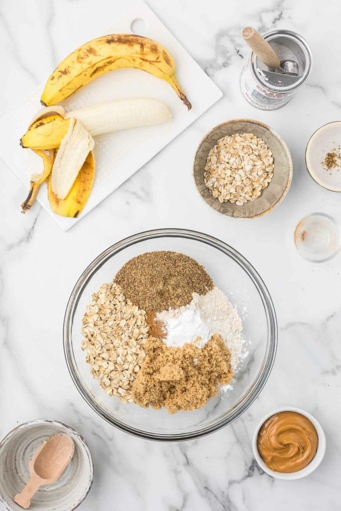 white whole wheat flour, oats, brown sugar, ground flax, and more dry baking ingredients in a bowl